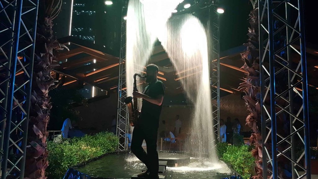 Event agency in Kuwait booked Saxophonist performing on water stage as part of the entertainment we supplied for Kuwait event