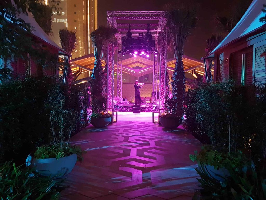 Musician performing on lite water stage. We provide global event management,, production, entertainment hire and logistics for this Kuwait event