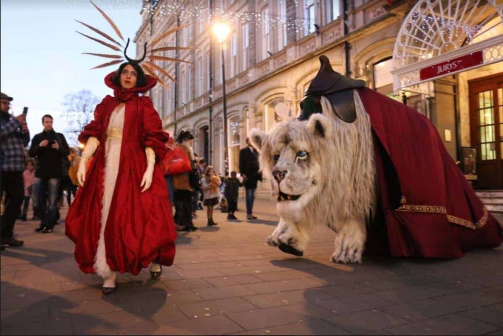 a woman in a red dress walking down a street.
